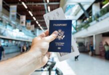 2026 护照办理还要等多久?美国国务院当前页面这几个时间点先记住 机场里旅客手持护照和登机牌准备出行
